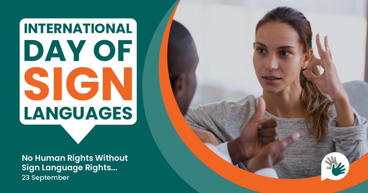 Graphic for International Day of Sign Languages, featuring bold text that reads ‘International Day of Sign Languages’ with the theme ‘No Human Rights Without Sign Language Rights… 23 September’. On the right, a woman signs in conversation with another person. A small logo of two overlapping hands is shown in the corner.